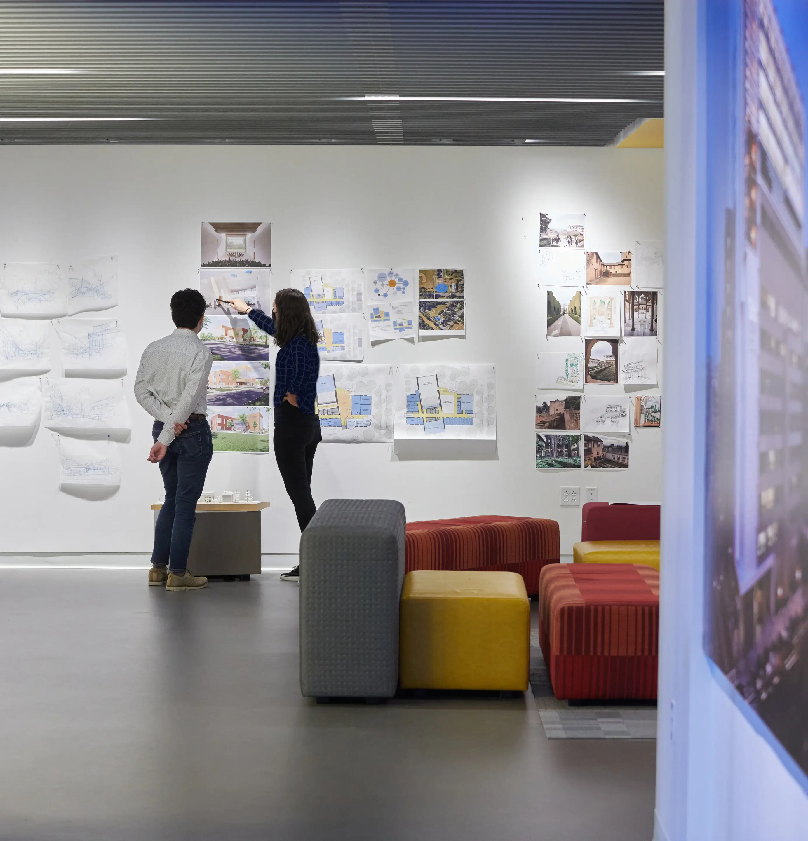 Two people looking at sketches