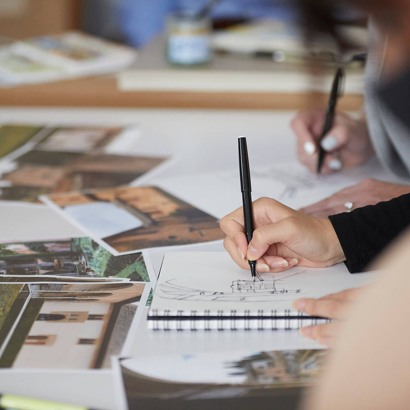 Detail of persons hands while they sketch 