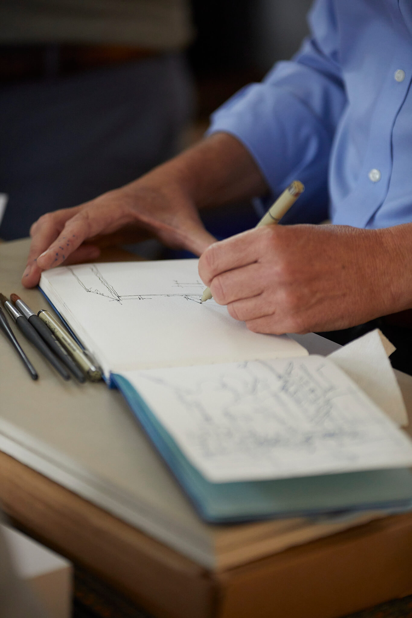 close up of hands sketching in notebook